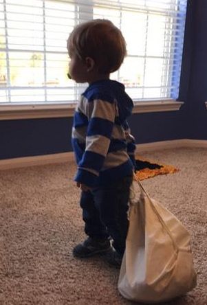 Josiah carrying his Bible story bag