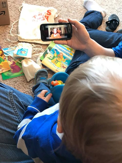 Josiah listening to Gramma read a Bible story